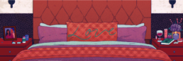 a red and purple bed with a pillow in the centre written with 